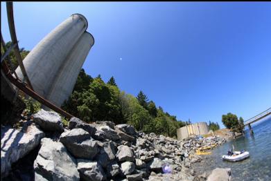fisheye view of silos and anchored boat
