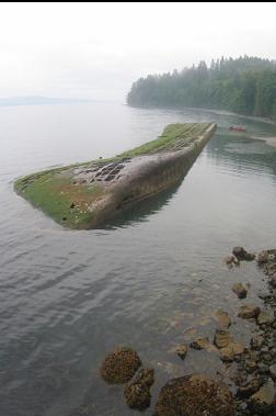 UPSIDE-DOWN BARGE AT LOW TIDE