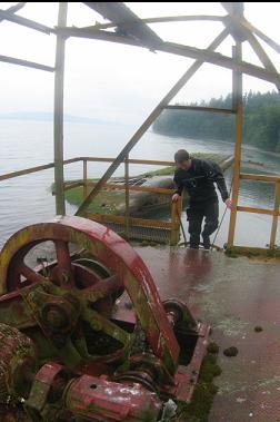 MACHINERY ON TOWER WITH BARGE IN BACKGROUND