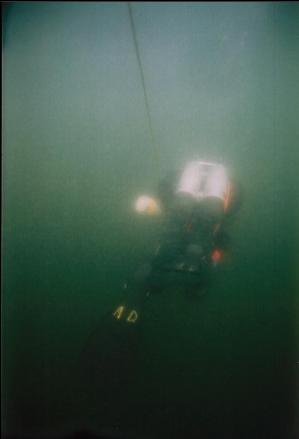 TECH DIVER DESCENDING THROUGH PLANKTON