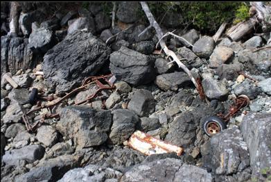 wreck of car at base of cliffs