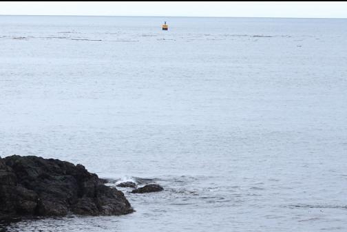 marker for Mouat Reef in the distance