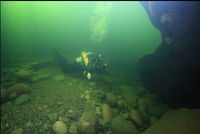 side of large boulder in middle of river