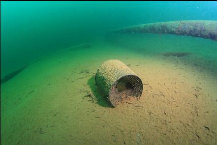 another mesh bucket-strainer next to the pipe