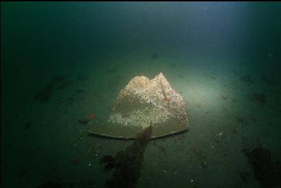 larger piece of junk on sand. Corner of dinghy?