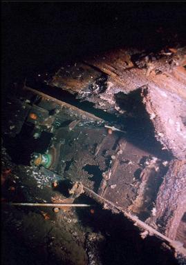 UNDER WRECKAGE AT BASE OF WALL