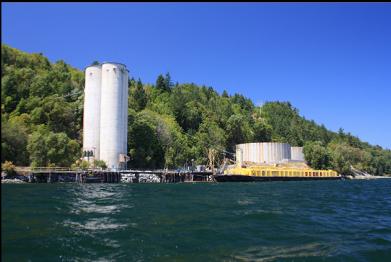 silos and yellow barge